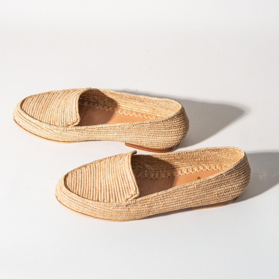 Mouna loafers angled on white, the woven upper and leather insole in view